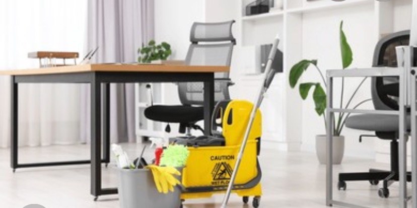Office desk area with a professional cleaning caddy ready for work